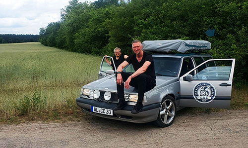 Team "WattmitBumms" sitzen auf der Motorhaube ihres Autos